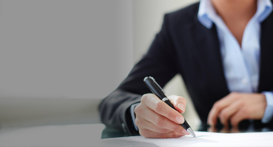 Businessman standing with arms crossed in office